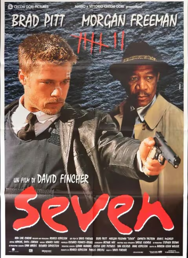 Si tratta di un poster cinematografico verticale per il film thriller "Seven" (stilizzato come "Se7en").

In primo piano e a sinistra c'è l'attore Brad Pitt (che interpreta l'investigatore David Mills), un uomo bianco con i capelli corti e biondi, che indossa una giacca di pelle scura, una camicia bianca e una cravatta. Il suo sguardo è intenso e rivolto in avanti, con il braccio destro teso in avanti e una leggera angolazione.

Alla sua destra e leggermente dietro c'è l'attore Morgan Freeman (che interpreta l'investigatore William Somerset), un uomo nero che indossa un cappotto chiaro e un cappello a tesa larga. Tiene una pistola nella mano destra, puntata nella stessa direzione di Pitt.

Lo sfondo è scuro, con una texture che suggerisce acqua o una superficie bagnata.

In alto ci sono i nomi degli attori principali: "BRAD PITT MORGAN FREEMAN".

Sotto di essi, è visibile il titolo del film in caratteri neri, scritto come se fosse cancellato: "7" (stilizzato come quattro barre verticali con una linea orizzontale che le taglia).

Il titolo principale, "Se7en", è in grassetto, con caratteri rossi e maiuscoli in fondo al poster.

Il poster trasmette un senso di drammaticità e tensione.